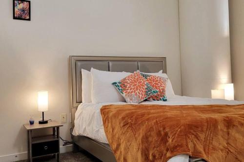 a bedroom with a large bed with two pillows on it at Naranja Loft #5 FREE Parking & Skywalk to Lucas Oil & Conv Center in Indianapolis