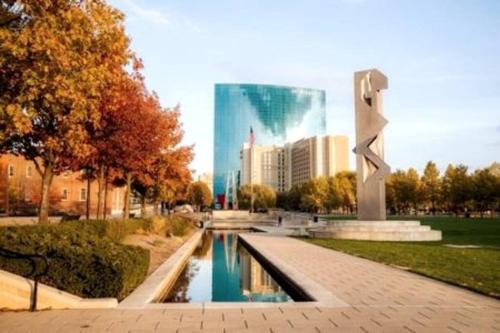 a fountain in a park in front of a city at Downtown Indy Lucas Oil Conv Center Skywalk#5 in Indianapolis
