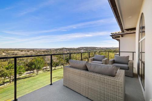 a patio with a couch and chairs on a balcony at Las Luces in Spicewood