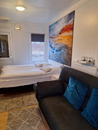 a bedroom with a large bed and a couch at Sólvellir Holiday Home in Kjósahreppur