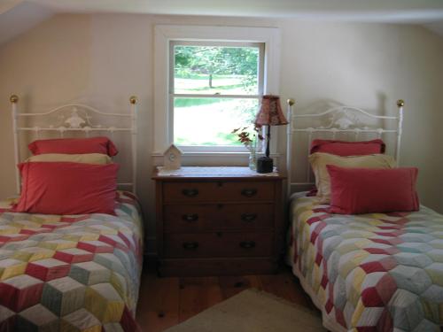 a bedroom with two beds and a window at Private setting on country farm near Rhinebeck in Clinton Corners