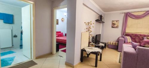 a living room with a couch and a chair and a table at Zoe's House in Epanomi