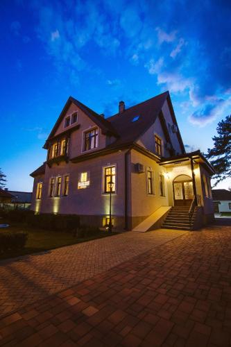 a large house with its lights on at Karlhof in Sebeş