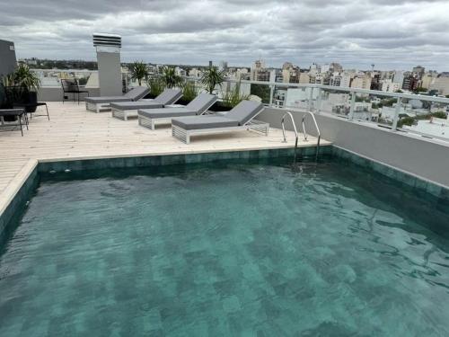 a swimming pool on the roof of a building at Penthouse 100m2 Piscina Gym Parrilla Salon de Eventos Cochera Apertura 2024 in Buenos Aires