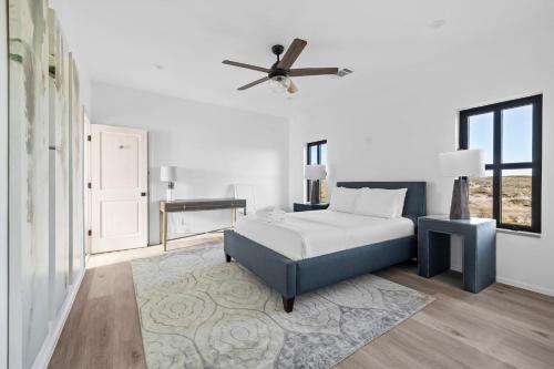 a bedroom with a bed and a ceiling fan at Las Luces in Spicewood