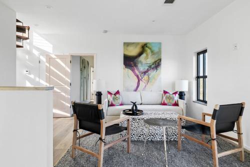 a living room with a white couch and a table at Las Luces in Spicewood