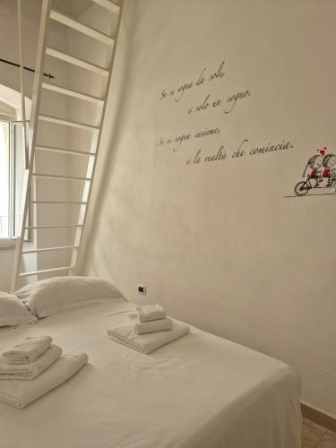 a bedroom with a bed with towels on it at Casa Aurora in Polignano a Mare