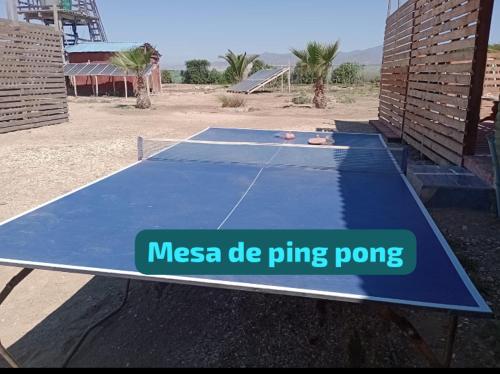 a blue ping pong table with a sign on it at Cabañas Las Murallas in Punta de Choros