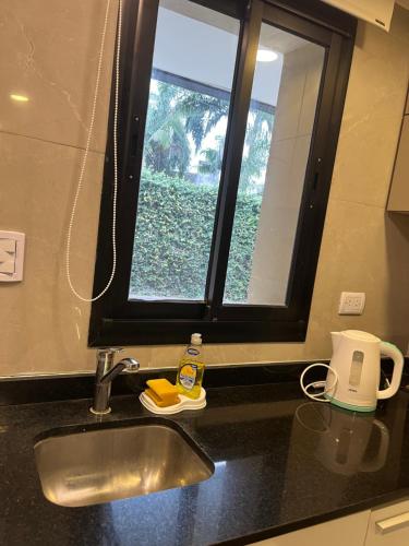 a kitchen counter with a sink and a window at Yerba Buena House in Yerba Buena