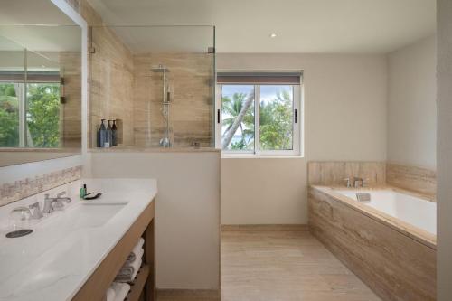 a bathroom with a tub and a sink and a bath tubermott at The Westin Puntacana Resort & Club in Punta Cana