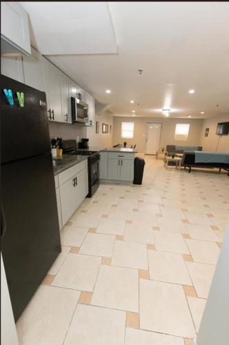 a large room with a kitchen with a large floor at Bright 2-Bed Haven Close to NYC in Jersey City