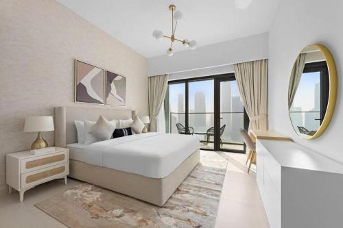 a white bedroom with a bed and a mirror at Burj Royale - Burj Khalifa View - 4m Walk to Dubai Mall in Dubai