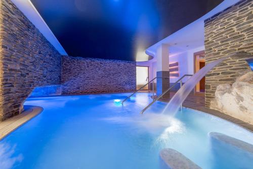 a pool in a house with a water slide at Sporthotel Neustift in Neustift im Stubaital