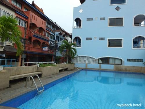 a swimming pool in front of a building at Royal Beach Guest House in Hua Hin