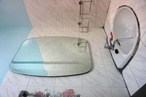 a bathroom with a mirror and a sink at Royal Beach Guest House in Hua Hin