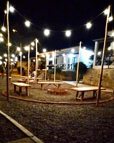 a group of picnic tables in a park at night at Casuarinas del Mar Habitacion Cerro 2 in Canoas De Punta Sal