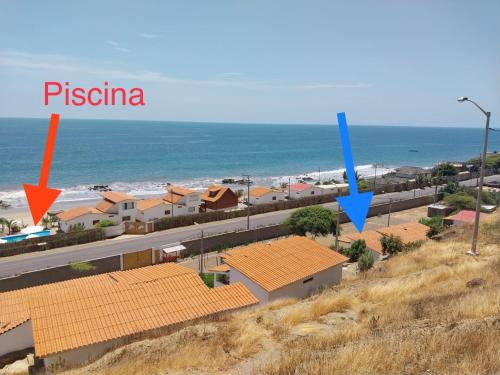 a view of a beach with buildings and the ocean at Casuarinas del Mar Habitacion Cerro 2 in Canoas De Punta Sal