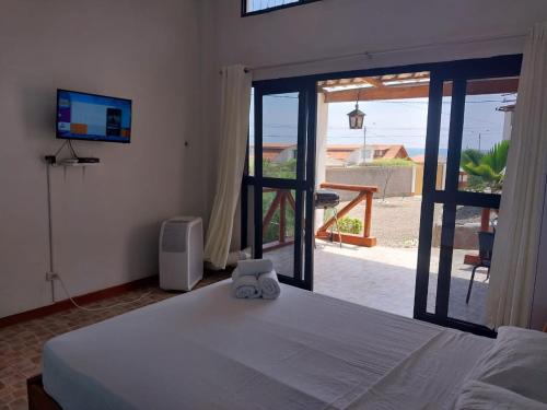 a bedroom with a bed and a view of the ocean at Casuarinas del Mar Habitacion Cerro 2 in Canoas De Punta Sal