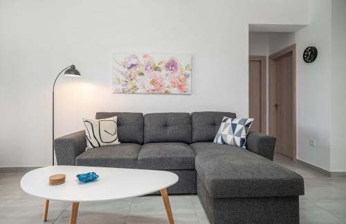 a living room with a couch and a table at Villa Zoi in Meson Yerakarion