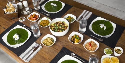a wooden table with plates of food on it at No 05 Middle Street in Galle
