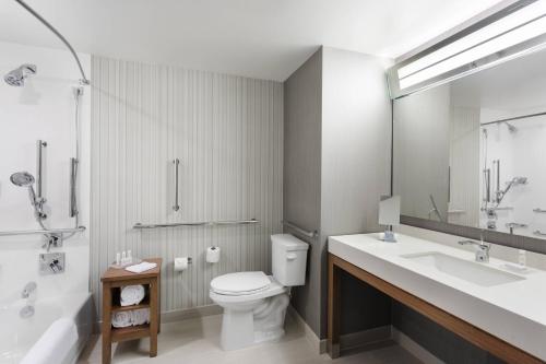 a bathroom with a toilet and a sink and a shower at Courtyard by Marriott Ruston in Ruston