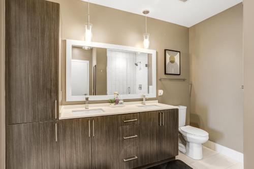 a bathroom with a sink and a toilet at Downtown Tampa Gem 1-BD w/Pool, Gym, & Sky Lounge in Tampa