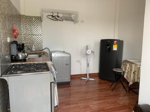 a kitchen with a stove and a refrigerator at Casa Oasis in Leticia