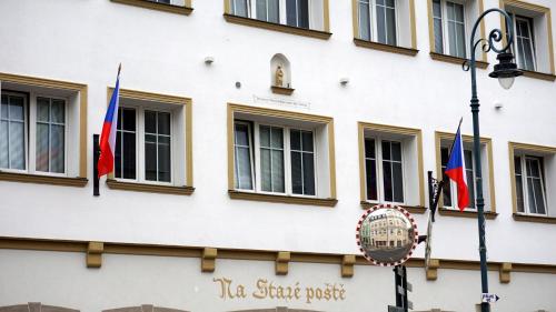 a building with flags on the side of it at Ubytování in Karlovy Vary