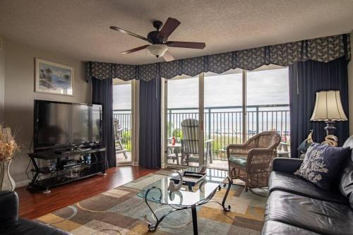 a living room with a couch and a flat screen tv at Windy Hill Dunes 104 condo in Myrtle Beach