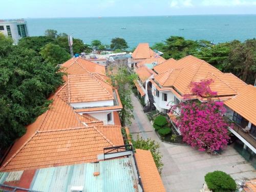 an aerial view of roofs of houses with flowers at VND Vũng Tàu Hotel & Villa in Vung Tau