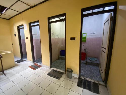 a room with three glass doors in a bathroom at Jogja Inn in Timuran