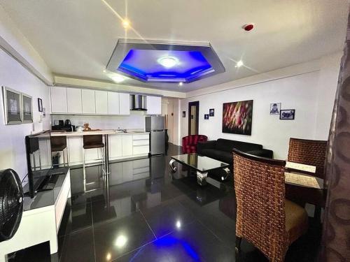 a kitchen and living room with a blue ceiling at Sheryll Escapes - Kandi luxury 1BR, housekeeping & Netflix! in Angeles