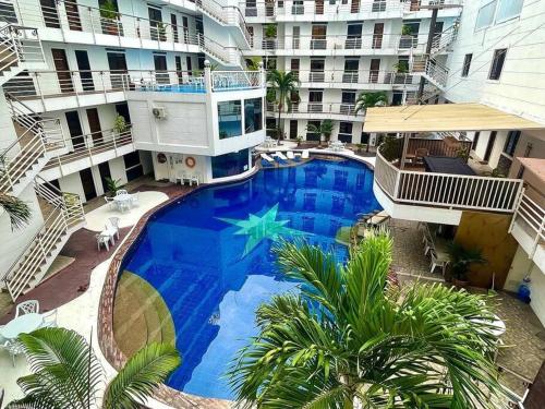 an overhead view of a swimming pool in a building at Sheryll Escapes - Kandi luxury 1BR, housekeeping & Netflix! in Angeles