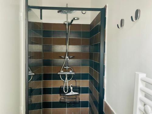 a bathroom with a shower with colorful tiles at Maisonette duplex - Tout equipé - Matelas haute qualité in Marly-le-Roi