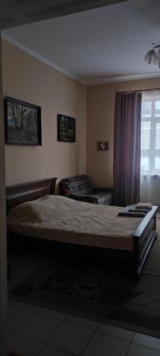 a bedroom with a large bed and a couch at Gelena Гостьовий двір in Uzhhorod