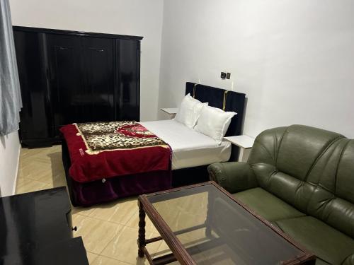 1 dormitorio con 1 cama, 1 sofá y 1 silla en Apparentement 3 meublée 1er étage en Oujda