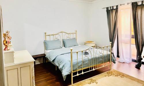 a bedroom with a bed with blue pillows at Room 1 Salina Seaview Retreat in Naxxar