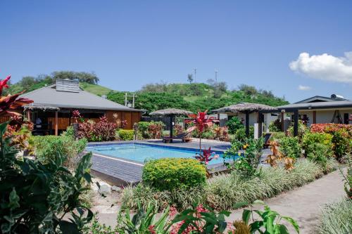SigatokaSeatiki Resort Fiji的一个带游泳池和房子的度假胜地