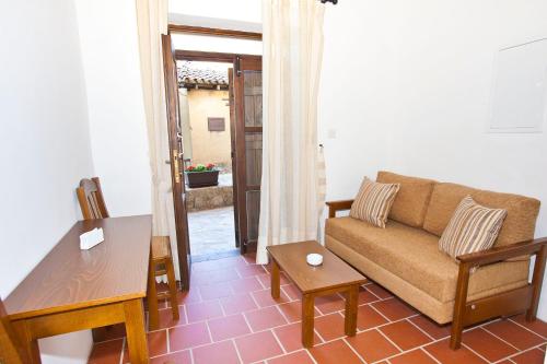 a living room with a couch and a table at Enipnion Apartments in Kakopetria