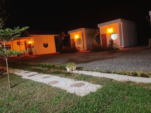 a house at night with a pathway in the yard at Muji House Resort in Non Sang