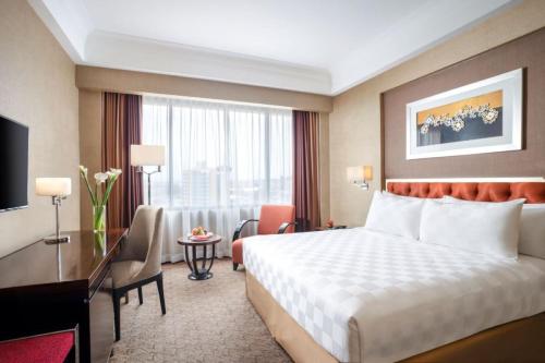 Postel nebo postele na pokoji v ubytování Hotel Ciputra Semarang managed by Swiss-Belhotel International