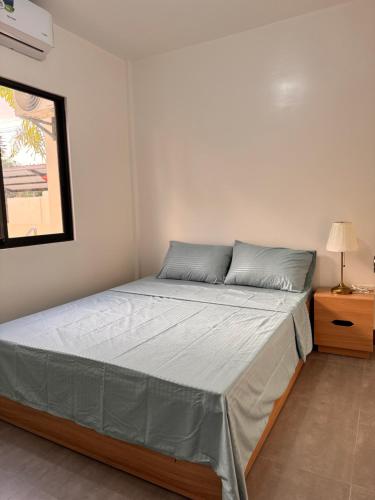 a bedroom with a bed in a room at Dano Private Resort and Apartments in Dauis