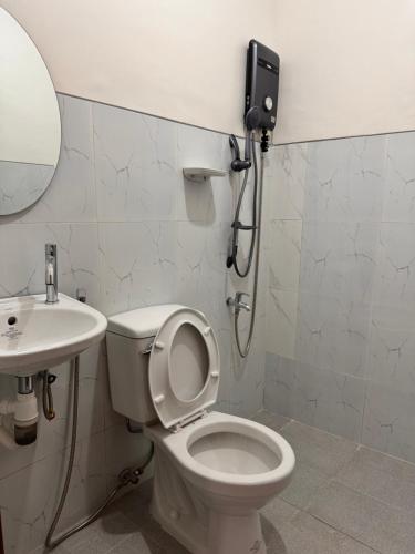 a bathroom with a toilet and a sink at Dano Private Resort and Apartments in Dauis