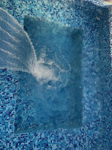 a water fountain with a letter in the middle at Rancho los olivos Habitaciones Campestres in San Miguel de Allende