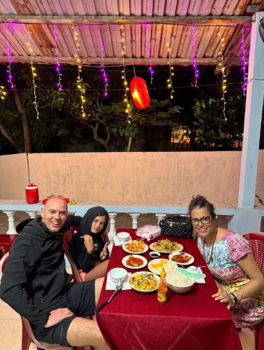 a group of people sitting around a table with food at Homestay Vân Đức Cù Lao Chàm in Tân Hiệp