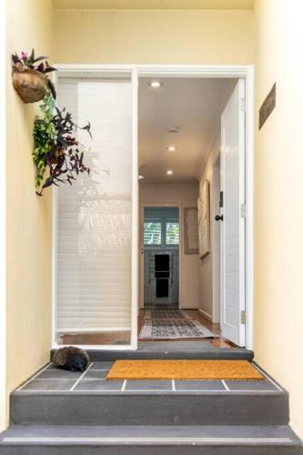a hallway of a home with a door open at Newly renovated 4 bedroom home in Newport with Pittwater views in Newport