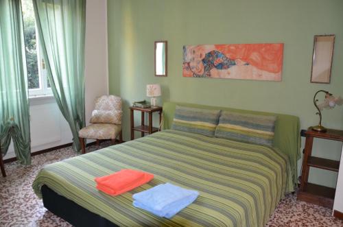 a bedroom with a bed with two towels on it at Green Quercia Apartment in Como