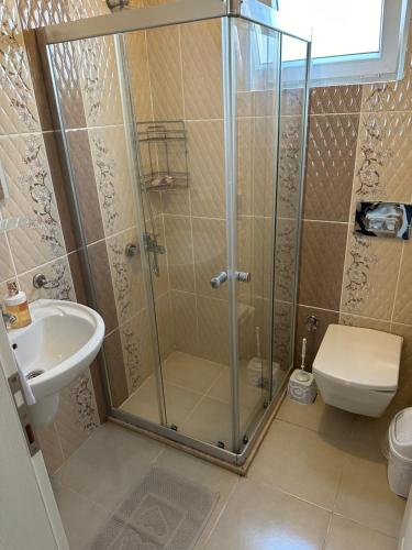 Un baño con ducha, inodoro y lavabo. en Fethiye Kiralık Daire, en Fethiye