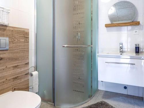 a bathroom with a glass shower with a toilet at Holiday cottages close to the beach, Jaros awiec in Jarosławiec