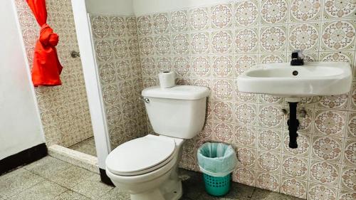 a bathroom with a toilet and a sink at Royal Palace Hostal in Panajachel
